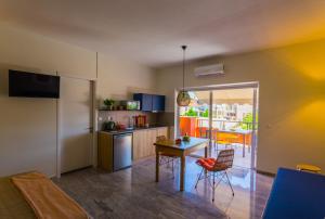 a kitchen with a table and chairs in a room at Koukounari Living Spaces in Preveza