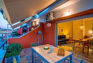 a living room with a table on a balcony at Koukounari Living Spaces in Preveza
