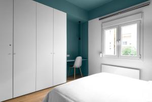 a bedroom with a bed and a window and a desk at Breen, Nilie Hospitality MGMT in Thessaloniki