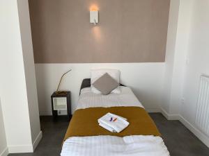 a bedroom with two beds with towels on them at Moov'Appart Hotel Clichy in Clichy +6 photos