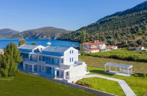 an aerial view of a house on a hill next to a lake at Notia Luxury Living in Porto Koufo