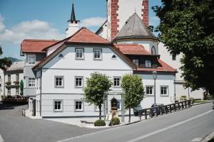 a large white building with a red roof at Tini´s Feinstes in Mariapfarr