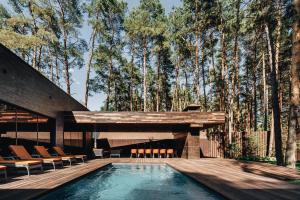 a house with a pool and a wooden deck at Verholy Relax Park in Sosnovka