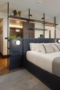a bedroom with a large bed with white pillows at Hotel SANSEbay in Donostia-San Sebastián +37 photos