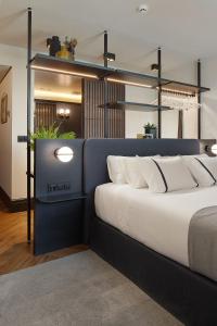 a bedroom with a bed and a lamp at Hotel SANSEbay in San Sebastián