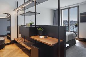 a bedroom with a bed and a desk in it at Hotel SANSEbay in Donostia-San Sebastián