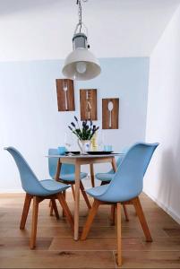 a dining room with a table and blue chairs at Velha 34 in Albufeira