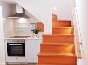 a kitchen with a staircase with a stove at Velha 34 in Albufeira +5 photos