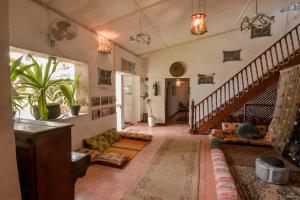 a living room with a staircase and a couch at Malindi Guest House in Zanzibar City