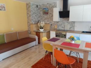 a kitchen and living room with a table and chairs at Noclegi u Pauliny i Pawła in Nowy Targ