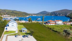 an aerial view of a house on a hill next to a lake at Notia Luxury Living in Porto Koufo