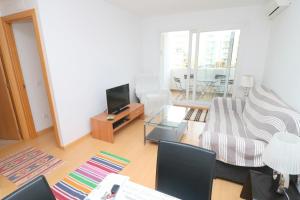 a living room with a couch and a tv at R. MARINE II (231) in Roses