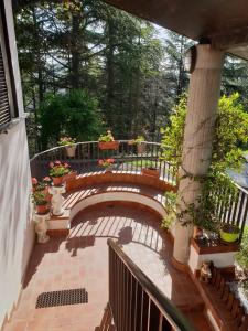a patio with a bench and a table with flowers at Il Giardino di Mai Exclusive B&b in Montabone