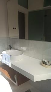 
a bathroom with a sink, mirror, and bathtub at Hotel Amphora in Chania Town
