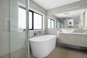 a bathroom with a large tub and a sink at Self Contained Beach View Apartment in Kingston Beach +17 photos