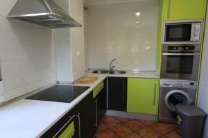 a small kitchen with a sink and a stove at Las Riendas casa rural in Muñeca