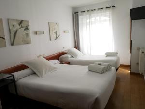 Postel nebo postele na pokoji v ubytování Hostal Carbonara
