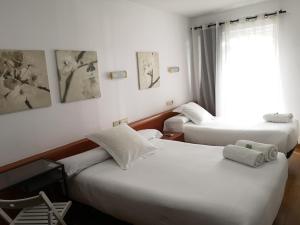 Postel nebo postele na pokoji v ubytování Hostal Carbonara