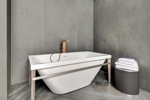 a bath tub sitting next to a toilet at Hotel Grano Old Town in Gdańsk