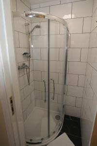 a shower with a glass door in a bathroom at Holland Inn Hotel in London