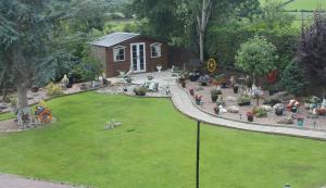 a small house in a yard with a garden at The Meadows B&B in Armagh