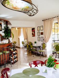 a dining room with tables and chairs and a chandelier at Oberża Złota Gęś in Siewierz