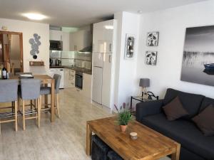 a living room and kitchen with a couch and a table at Our Sol in Puerto de Mazarrón