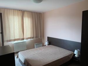 a bedroom with a bed and a large window at Апартамент в комплекс Bansko Royal Towers in Bansko +27 photos