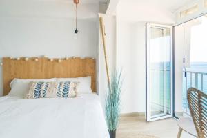 a bedroom with a bed and a view of the ocean at Sugar Beach Boutique Studio in Platja d'Aro
