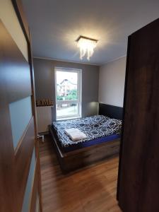 Ένα ή περισσότερα κρεβάτια σε δωμάτιο στο Zjawiskowy Apartament Bel Mare Parking Basen