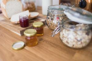 a wooden table with jars of food on it at Flore House in Flore
