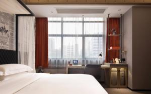 Llit o llits en una habitació de Arthur Hotel Zhujiang New Town Guangzhou-Pazhou Exhibition Center Branch