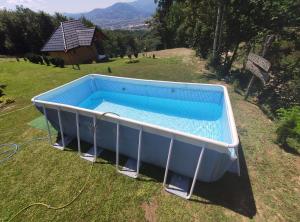 an overhead view of a swimming pool in a field at Suncevica Apartmani in Arilje