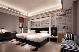 Llit o llits en una habitació de Arthur Hotel Zhujiang New Town Guangzhou-Pazhou Exhibition Center Branch