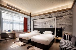 Llit o llits en una habitació de Arthur Hotel Zhujiang New Town Guangzhou-Pazhou Exhibition Center Branch