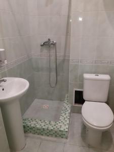 a bathroom with a toilet and a sink at РАЗЪЕЗЖАЯ ул 42 in Saint Petersburg