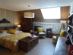 a bedroom with a bed and a table and chairs at Ferme de la grande Moucherolle in Villard-de-Lans