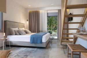 een slaapkamer met een bed en een ladder erin bij Notia Luxury Living in Porto Koufo