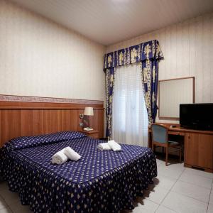 Ένα ή περισσότερα κρεβάτια σε δωμάτιο στο Hotel Capys