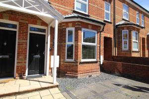 a brick house with a front door and windows at Corbiere House @ Short Stays in Basingstoke
