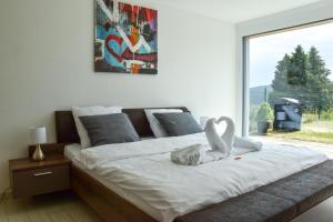 una camera da letto con un letto con due cigni sopra di Chez Julia a Tramelan
