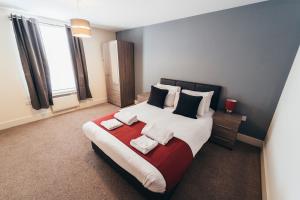 a bedroom with a large bed with two pillows at The Stay Company, Dalby House in Derby