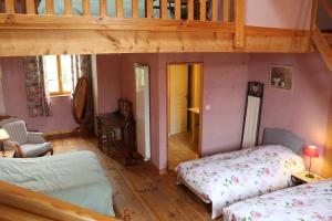 a small room with two beds and a staircase at COMME UN COQ EN PÂTE in Bourg-le-Comte