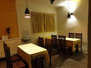 a dining room with two tables and chairs at Shiva Rest Katharagama in Kataragama