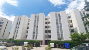 a large white building with cars parked in front of it at Bed and Breakfast My home in Pisa