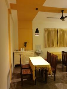 a kitchen with a table and chairs and a dining room at Shiva Rest Katharagama in Kataragama