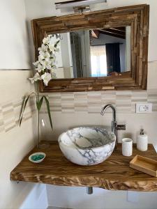 a bathroom counter with a sink and a mirror at Ca LuBella in Carrara