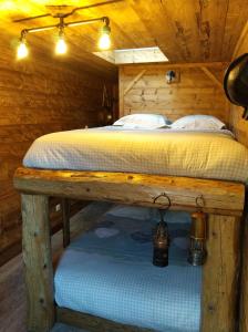 a bedroom with a bed in a cabin at L'Entre 2 Cols in Saint-Martin-sur-le-Chambre