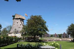 a building with a tower with a flag on it at Villa Klein Geluk in Egmond aan Zee
