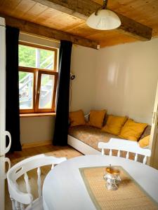 a living room with a couch and a table at Lejnieki Apartment 2 in Pape +11 photos